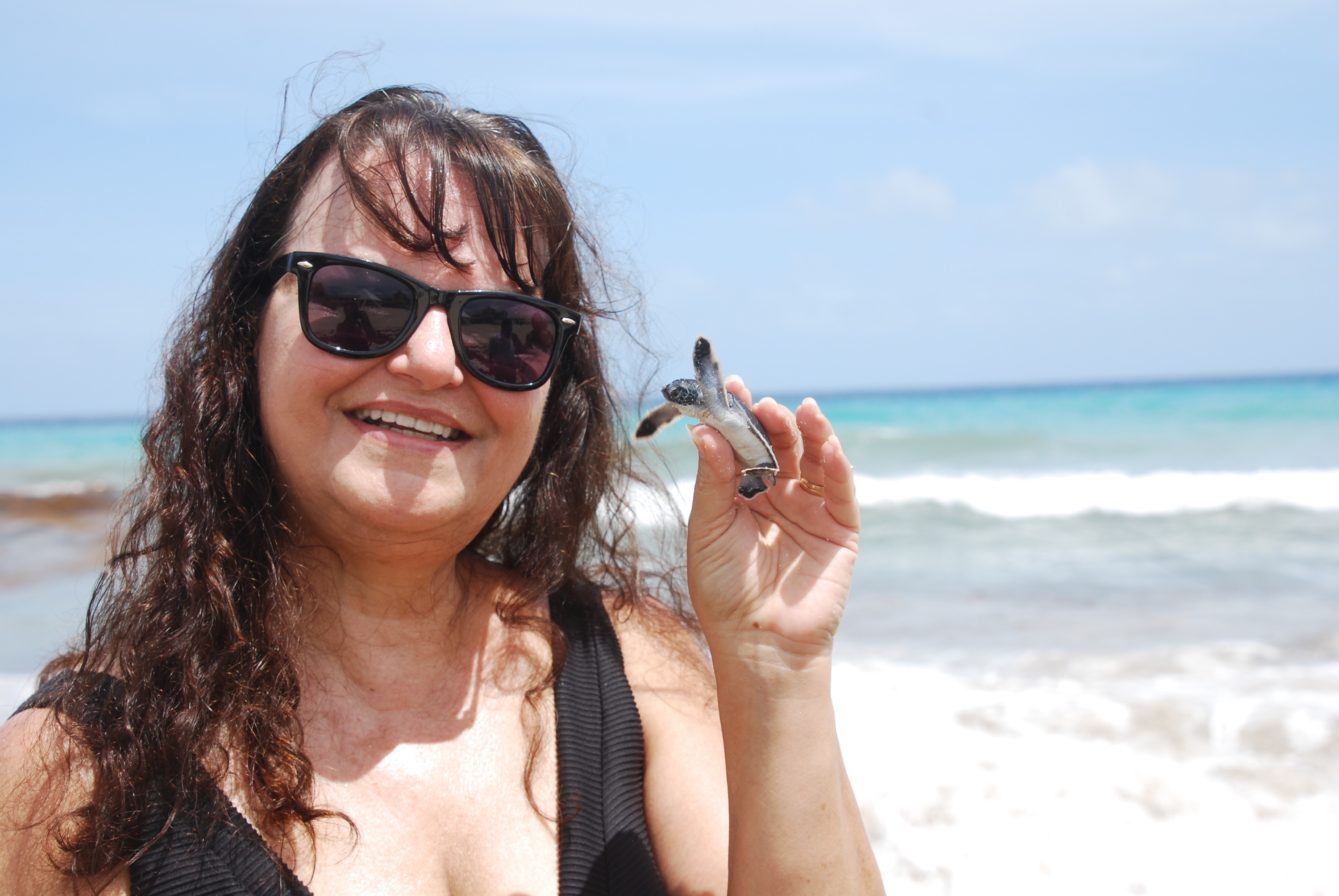 Thats me holding a newly hatched sea turtle found on the beach in Cancun! what a wonderful experience! Photo copyright Valerie Duty Citrano